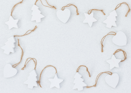 White wooden handmade christmas tree toys on light background. Copy space for text. Winter greeting card. Handmade christmas conceptの写真素材