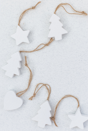 White wooden handmade christmas tree toys on light background. Copy space for text. Winter greeting card. Handmade christmas conceptの写真素材