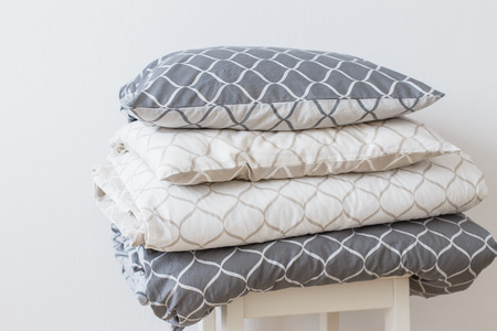 Two bedding sets in grey and beige, cool for two children, for siblings. Modern bed linen, in trend, minimalism clean home conceptの写真素材