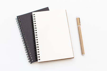Blank notebook and pen on white background. Notepad space for text inputの写真素材
