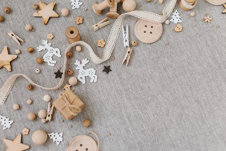 Craft and wooden Christmas flatlay on farbic background. Wooden supplies, cotton lace and christmas symbols. Place for textの写真素材