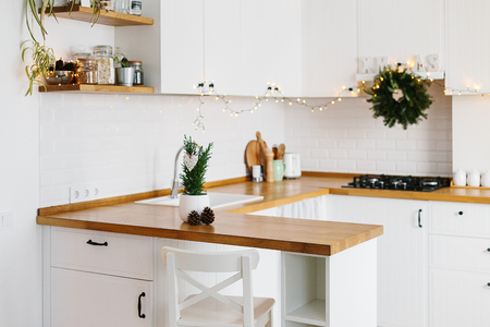Small Christmas tree in white flower pot white modern kitchen scandinavian style decorated for Christmas background. Cypress, Chamaecyparis lawsoniana Ellwoodiiの写真素材