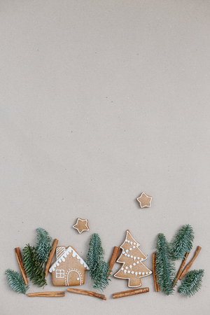 Christmas composition homemade gingerbread cookies. Gingerbread house shape in the fir branches forrest. Building conceptの写真素材