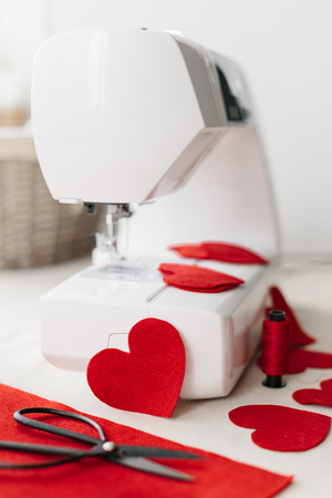 Hnadmade felt red heart sewing machine scissors. Valentines day concept.の写真素材