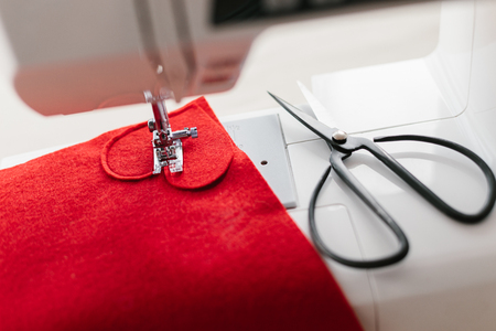 Hnadmade felt red heart sewing machine scissors. Valentines day concept.の写真素材