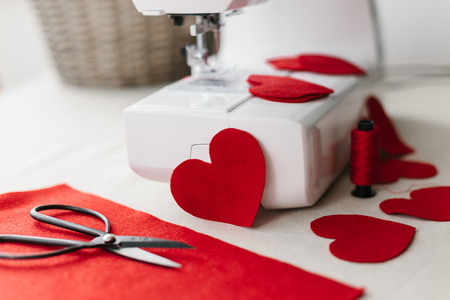 Hnadmade felt red heart sewing machine scissors. Valentines day concept.の写真素材