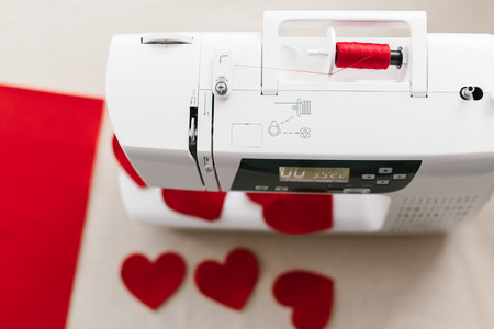 Hnadmade felt red heart sewing machine scissors. Valentines day concept.