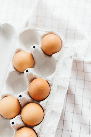 Eggs in egg tray on white kitchen towel. Selective focusの写真素材