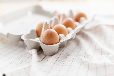 Eggs in egg tray on white kitchen towel. Selective focusの写真素材