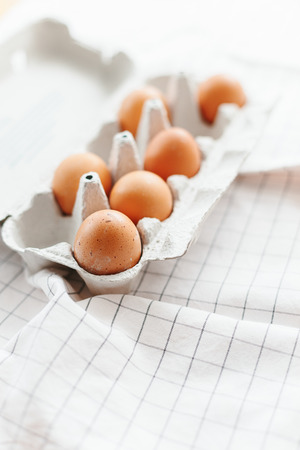 Eggs in egg tray on white kitchen towel. Selective focusの写真素材
