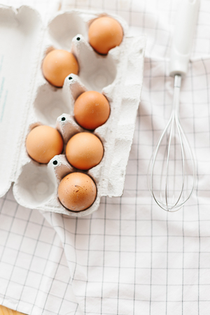 Eggs in egg tray on white kitchen towel. Selective focusの写真素材