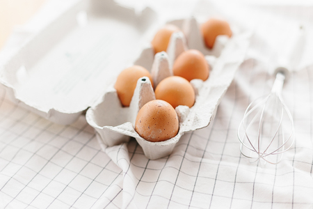 Eggs in egg tray on white kitchen towel. Selective focusの写真素材
