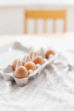 Eggs in egg tray on white kitchen towel. Selective focusの写真素材