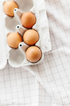 Eggs in egg tray on white kitchen towel. Selective focusの写真素材