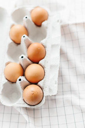 Eggs in egg tray on white kitchen towel. Selective focusの写真素材