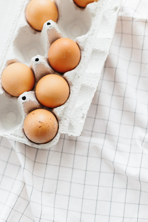 Eggs in egg tray on white kitchen towel. Selective focusの写真素材