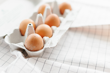 Eggs in egg tray on white kitchen towel. Selective focusの写真素材