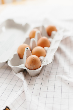 Eggs in egg tray on white kitchen towel. Selective focusの写真素材