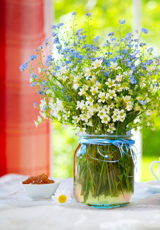 Spring wild flowers bouquet on the tableの写真素材