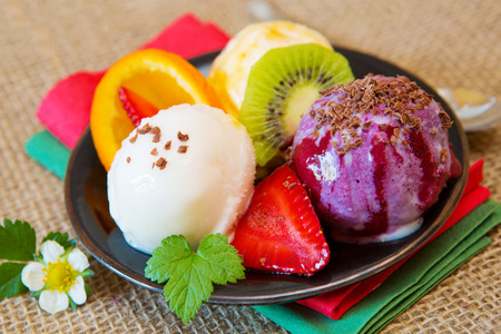 Ice cream with strawberry  isolated on brown cloth  background.Mixed fruit ice.の写真素材