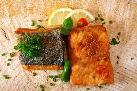 Salmon steak with lemon on wooden background.の写真素材