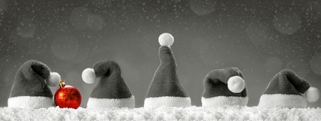 Seven red santa hats isolated on grey  background.Christmas  grey  background with Santa hats.Red Santa hats.の写真素材