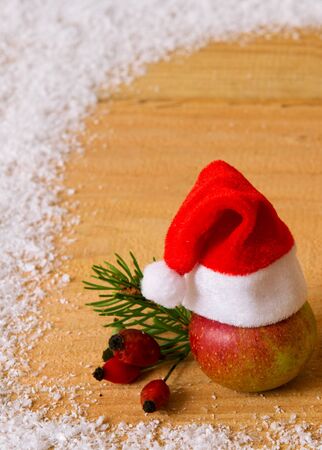 Red Santa Hat  and Snow frame.Christmas decoration and Santa Hat isolated on wood background.の写真素材