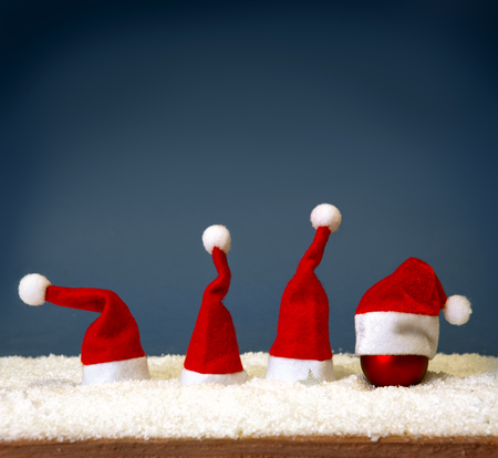 White snow  with Christmas hats misolated on grey  background.Christmas decoration.の写真素材
