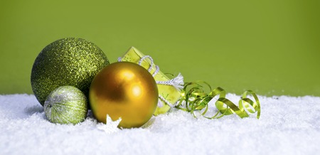 Green christmas balls isolated .Christmas decoration and snow background.の写真素材
