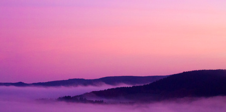 Beautiful foggy morning  in the mountains.Mountains under mist in the morning .の写真素材