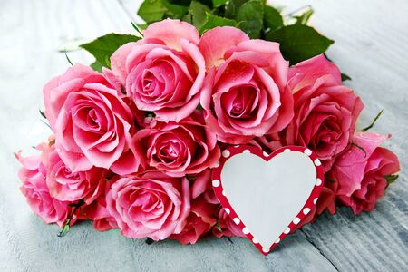 Mothers day greeting card or photo frame and pink rose over wooden table.の写真素材