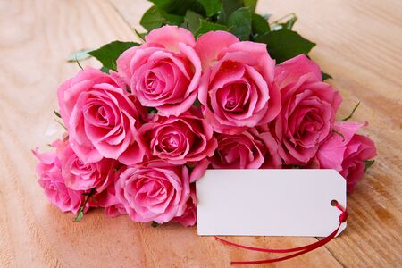 Mothers day greeting card or photo frame and pink rose over wooden table.の写真素材