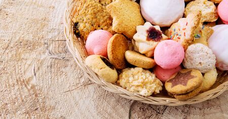 Various Christmas cookies isolated on wood background. Christmas background. Christmas cookies in...