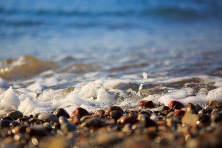 Sand beach and sea foam macro with narrow focus background.