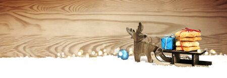 Christmas cookies and wood deer on sledge.