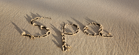 Word Spa written on the sand near the sea. Wellness concept written on sand.の写真素材