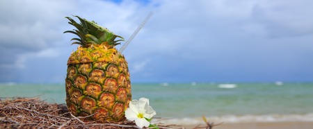 Pina Colada in pineapple in the sand of the beach with the beautiful Caribbean sea in the...