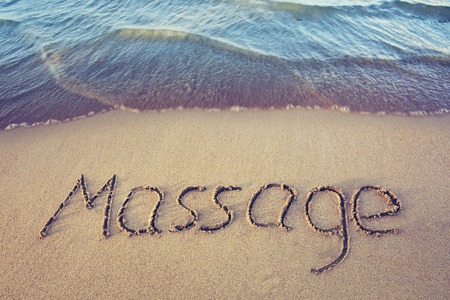 Word Massage written on the sand near the sea.の写真素材