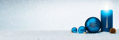 Christmas background with first Advent candle and blue bauble isolated.の写真素材