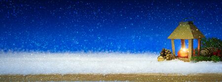 Christmas lantern on white snow.Winter blue background.