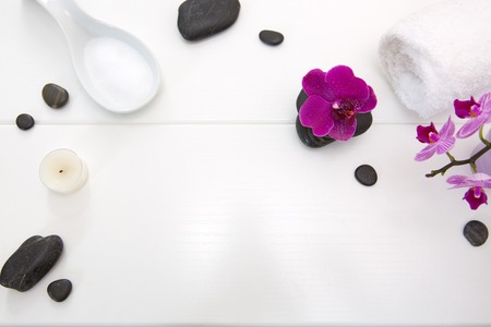 Spa setting with pink orchids , black stones and candle on wood background.の写真素材