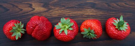 Macro shot on strawberries over wooden background.の写真素材