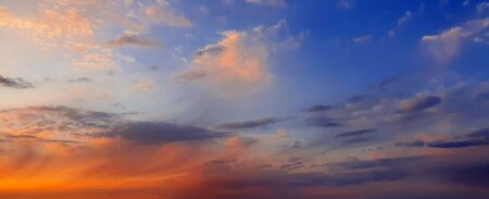 Colorful dramatic sky with big clouds and sunsetの写真素材