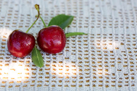 Close up of big red cherries with water drops on the table.の写真素材