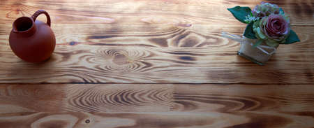 Bouquet of pink roses in a basket on brown wooden background.の写真素材