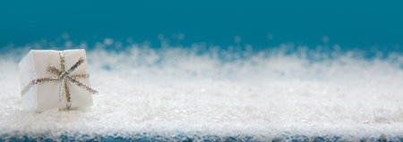 White christmas gift isolated on blue background.の写真素材