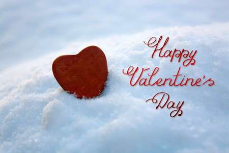 Red heart in the snow.の写真素材