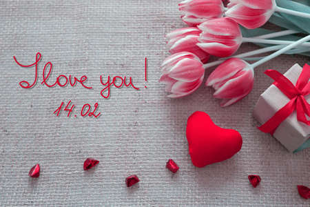 Valentines day background with tulips and red heart on cloth Background.