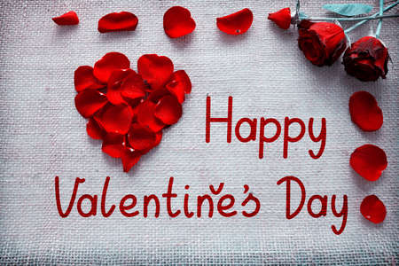 Valentines day background with heart of roses petals isolated .