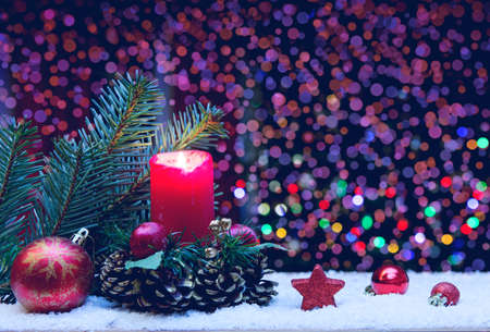Advent candle with decorations and fir tree isolated on lights background.